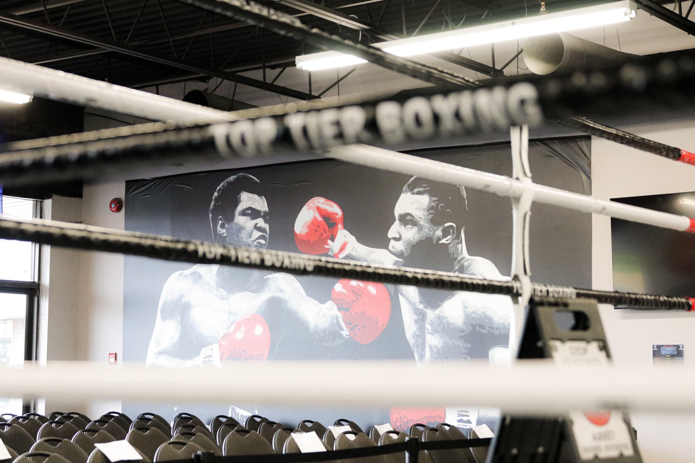 Boxing ring at Top Tier Boxing Club with the Ali–Tyson mural