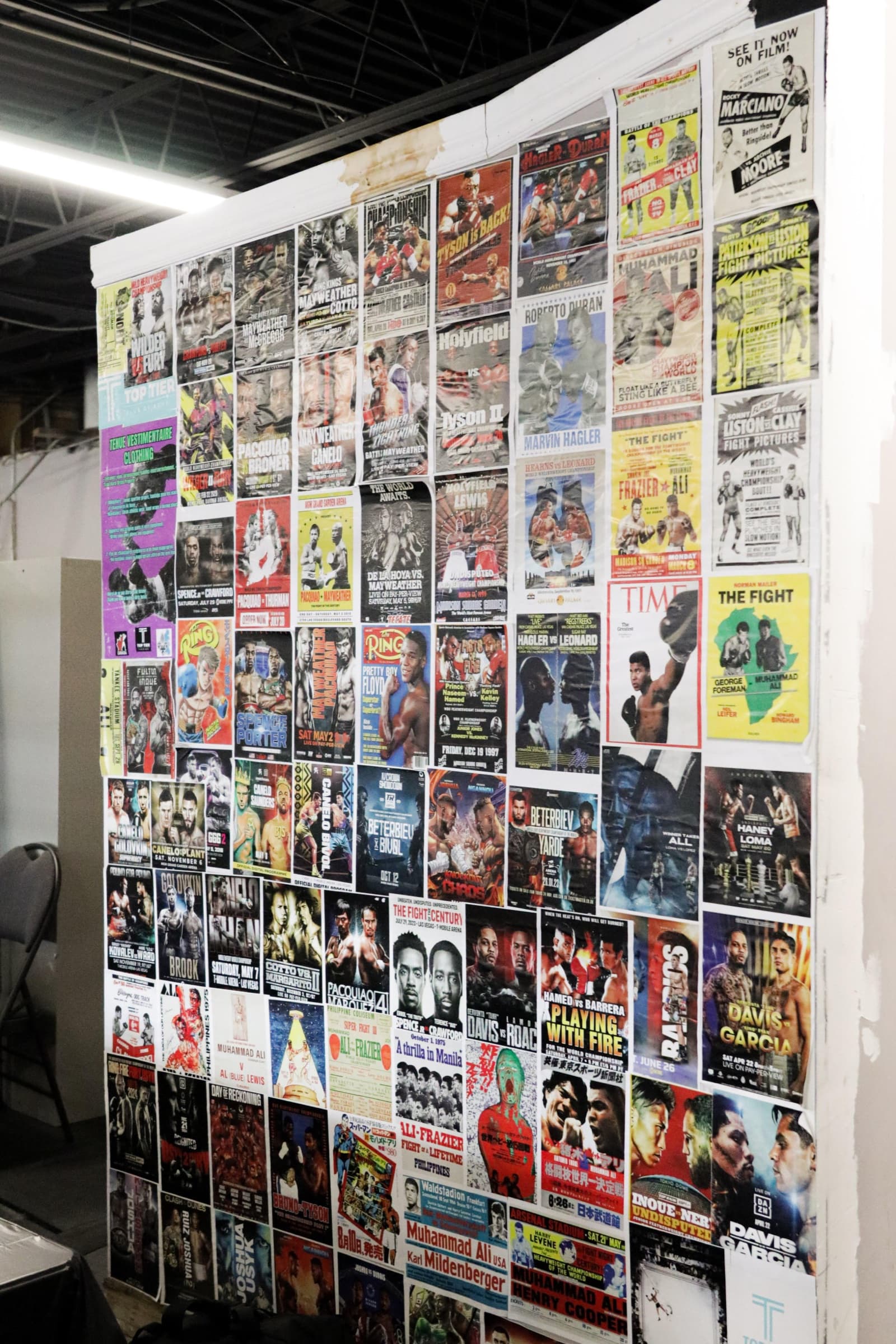 Wall of classic fight posters at the gym